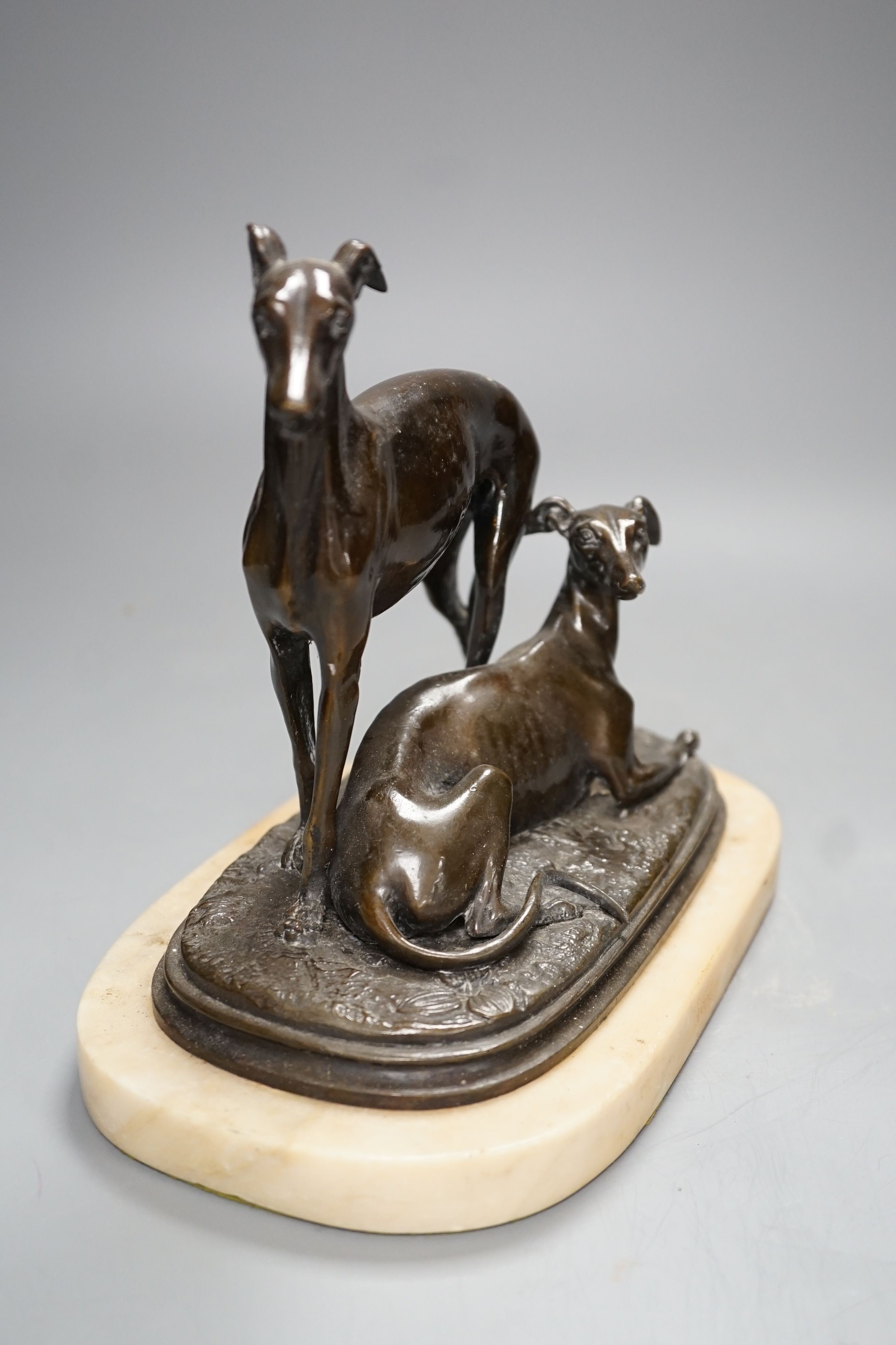 A bronze sculpture of a greyhounds on alabaster base, one seated and the other standing - 20cm high